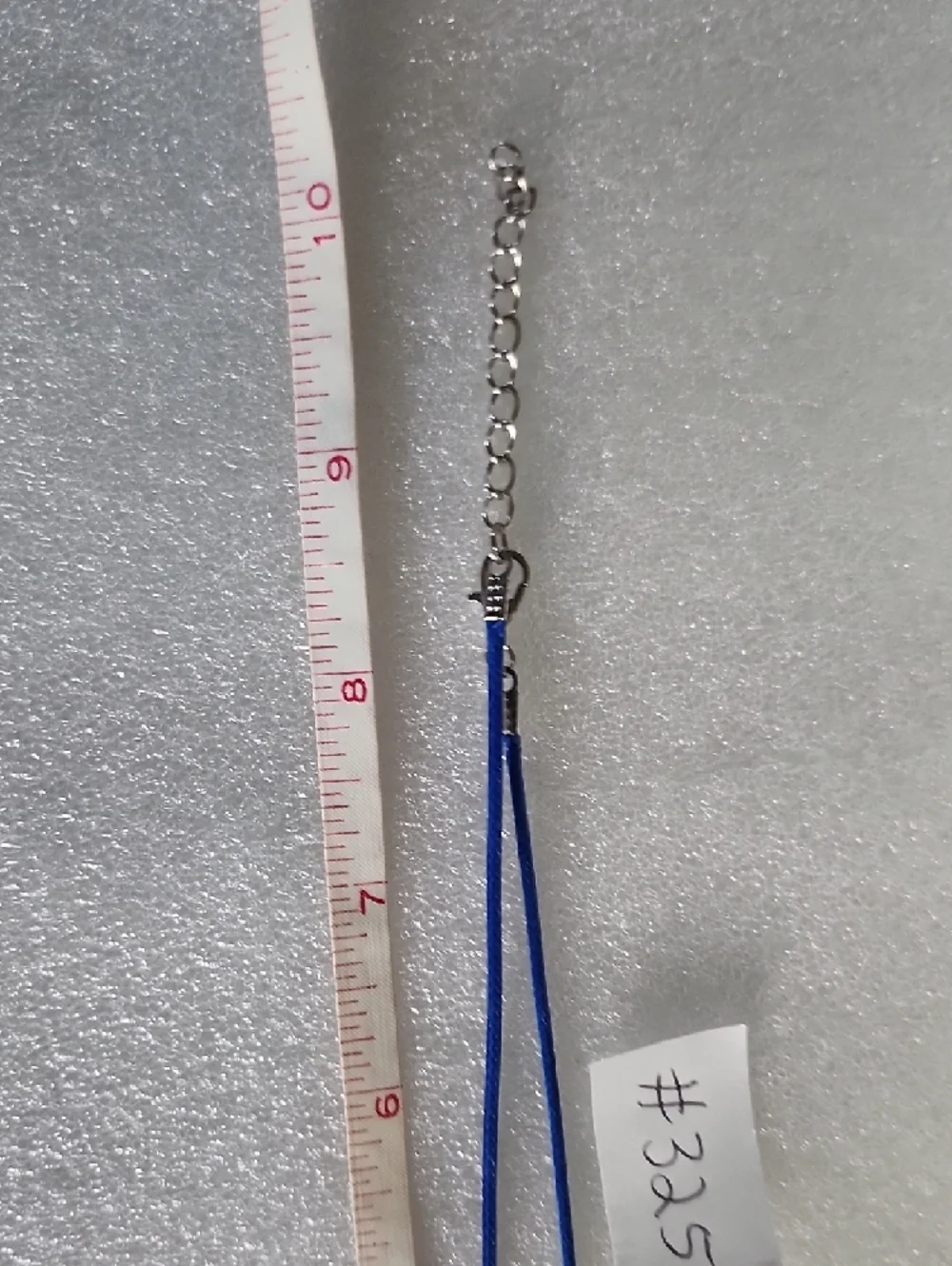 Hand Crafted Blue Gingerbread Man Necklace with Pink Bow
